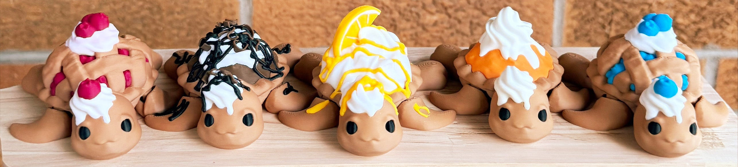 Row of small pie turtles figurines with various toppings on a wooden board.